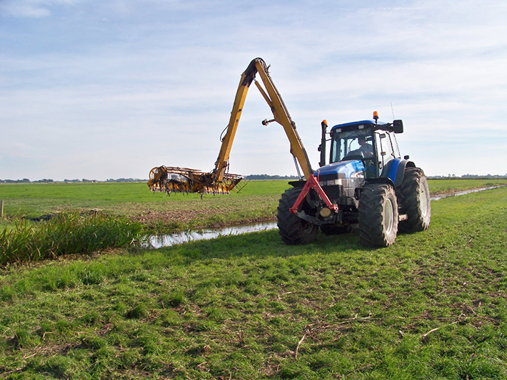 A tractor with a machine that cleans the ditch
