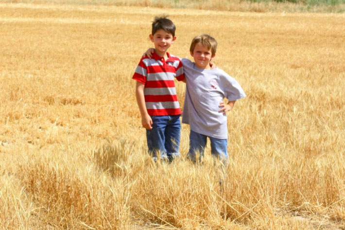Childern in the wheat field after harvest.