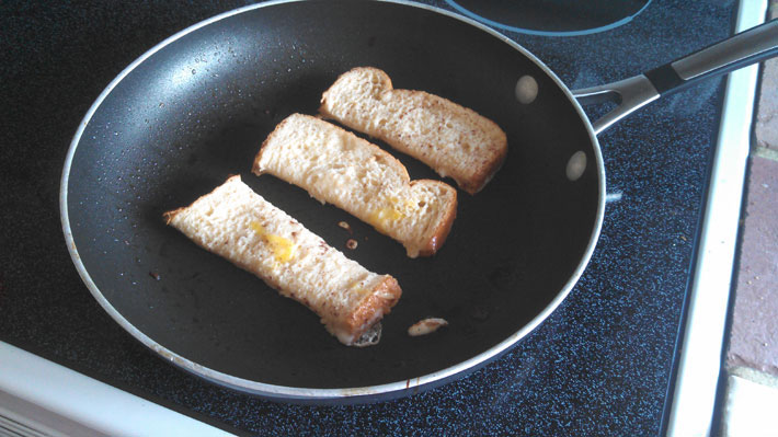 I then cut the bread into three pieces so they were little sticks of French toast. Before I put them in the pan I coated them with the ingredients that I mixed together in the bowl.