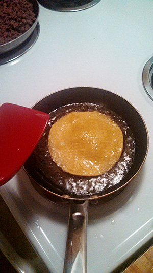 Once the oil is hot enough I put one tortilla into the oil. I place it in carefully as to not burn myself. I place it in a only leave it on one side for about thirty seconds to a minute, flip it and do the same thing for the other side. I then place it on a plate and continue to do it for how ever many more tortillas I want.